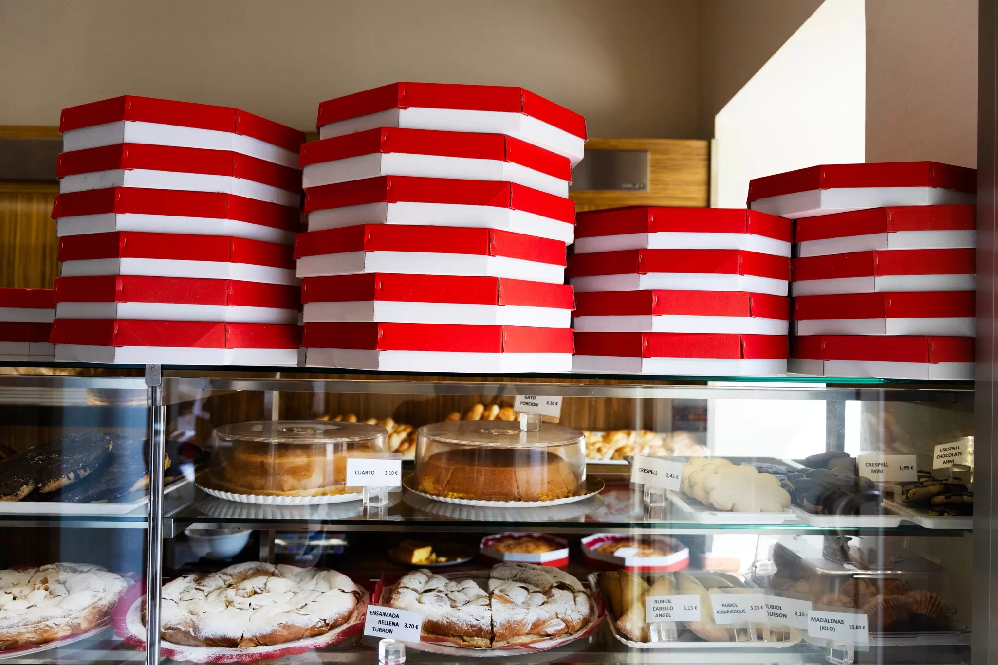 Boxes of ensaïmadas and other treats stacked in a local bakery, ready for customers in Palma de Mallorca. Felipe Santibañez for Lonely Planet