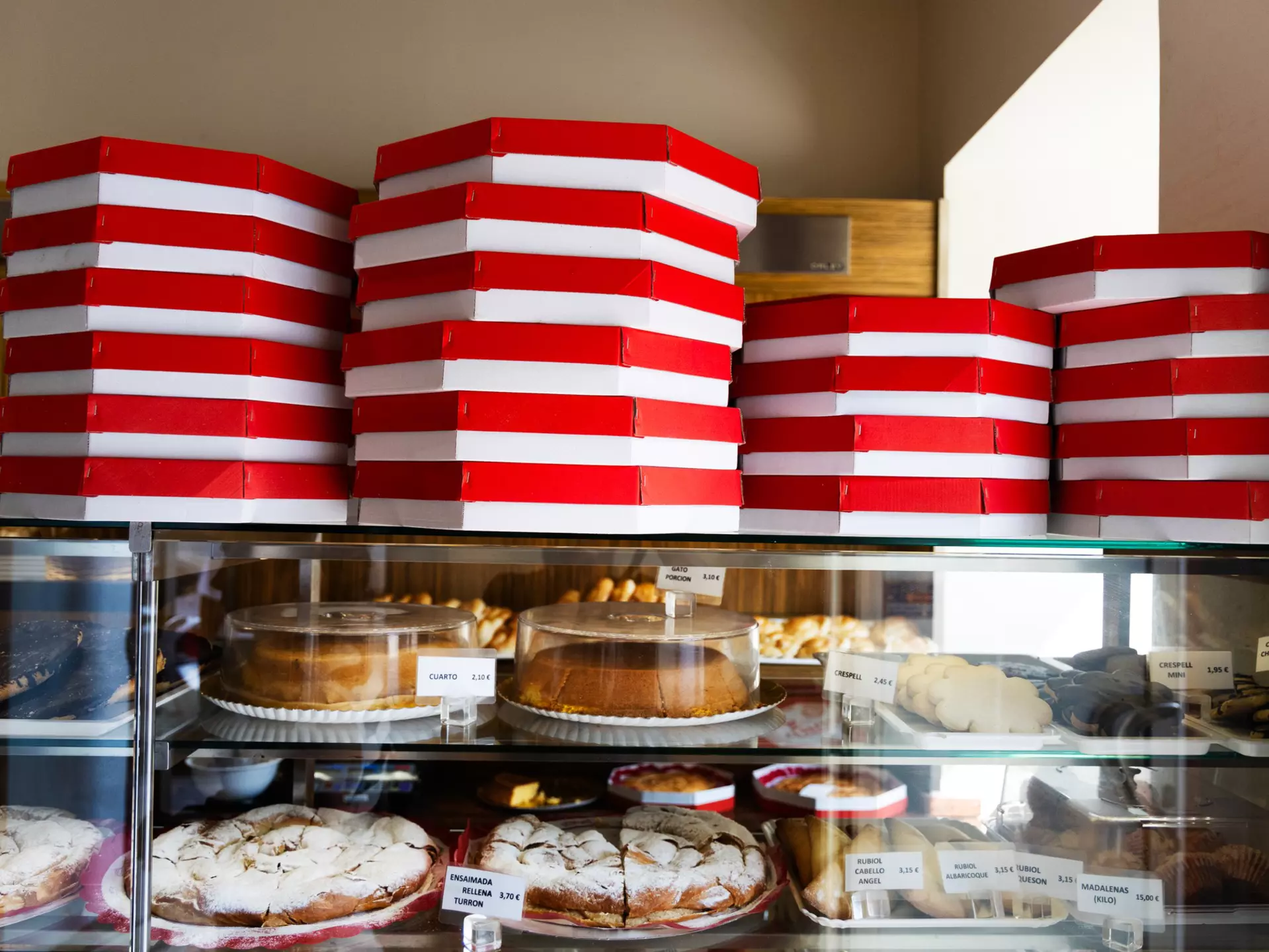 Boxes of ensaïmadas and other treats stacked in a local bakery, ready for customers in Palma de Mallorca. Felipe Santibañez for Lonely Planet
