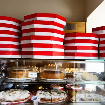 Boxes of ensaïmadas and other treats stacked in a local bakery, ready for customers in Palma de Mallorca. Felipe Santibañez for Lonely Planet