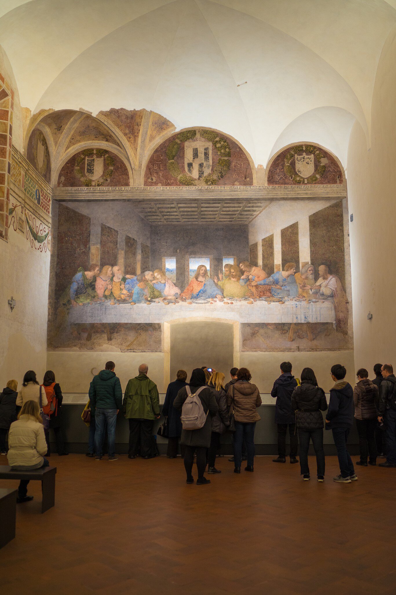 Tourists examining the Last Supper in the refectory of the Convent of Santa Maria delle Grazie.