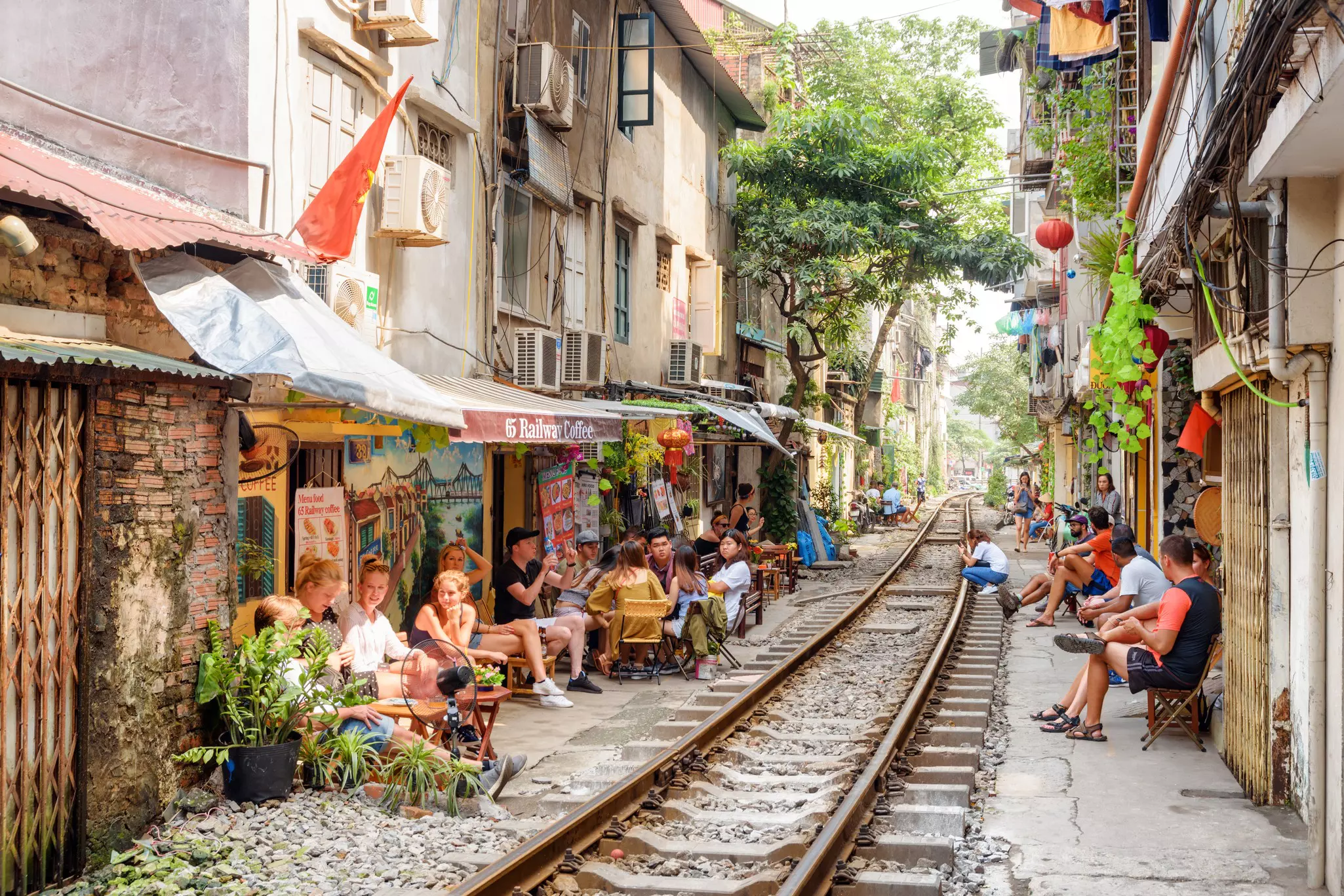 Tourists and residents waiting a passing train at the Hanoi Train Street