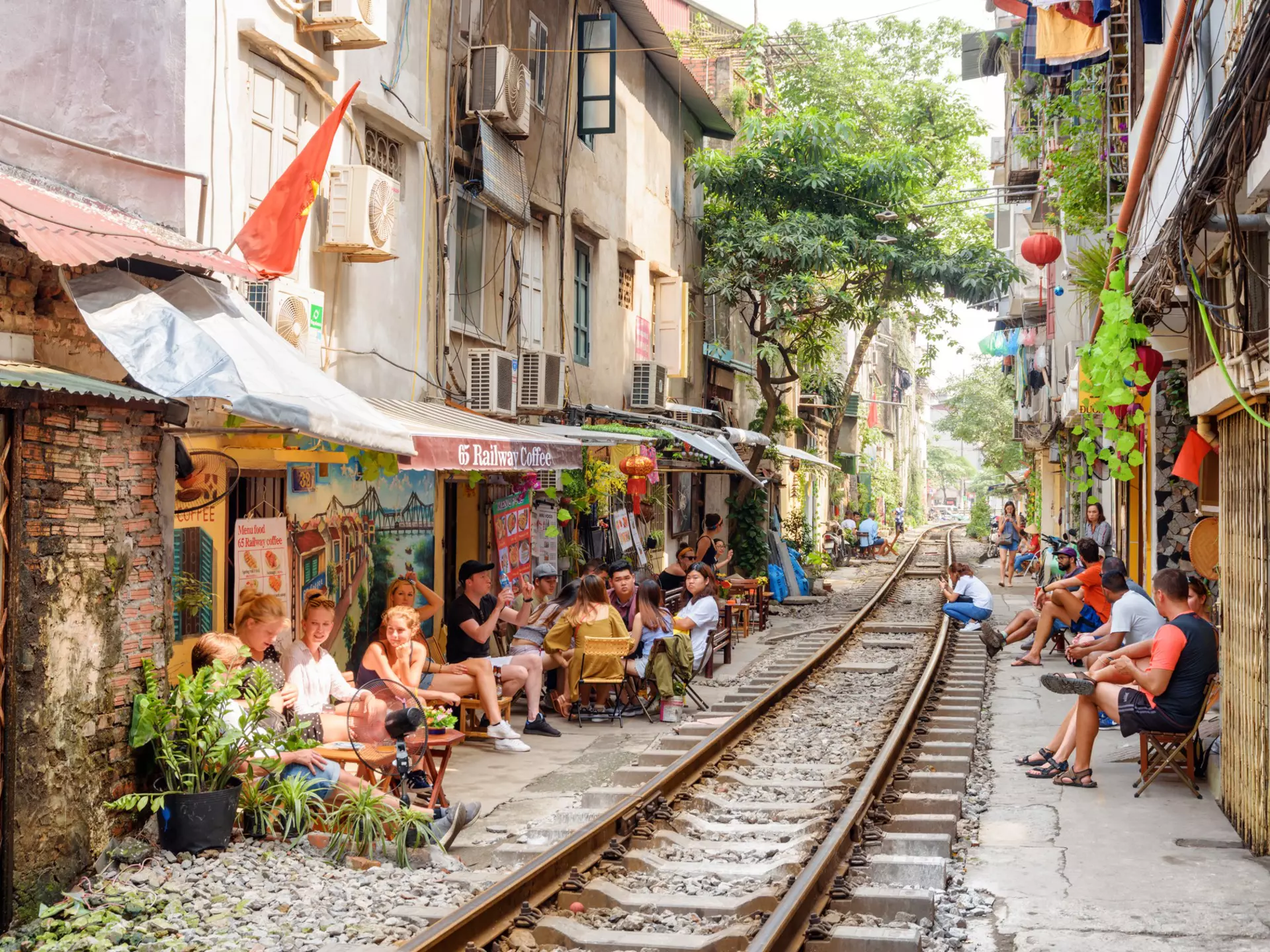 Tourists and residents waiting a passing train at the Hanoi Train Street