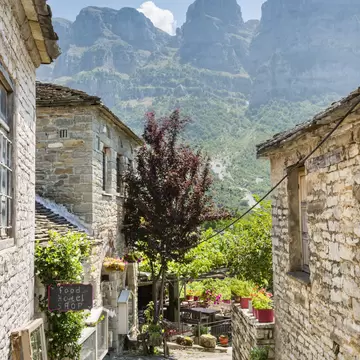 Cobbled stone laneway with mountains in background, Papingo, Greece.