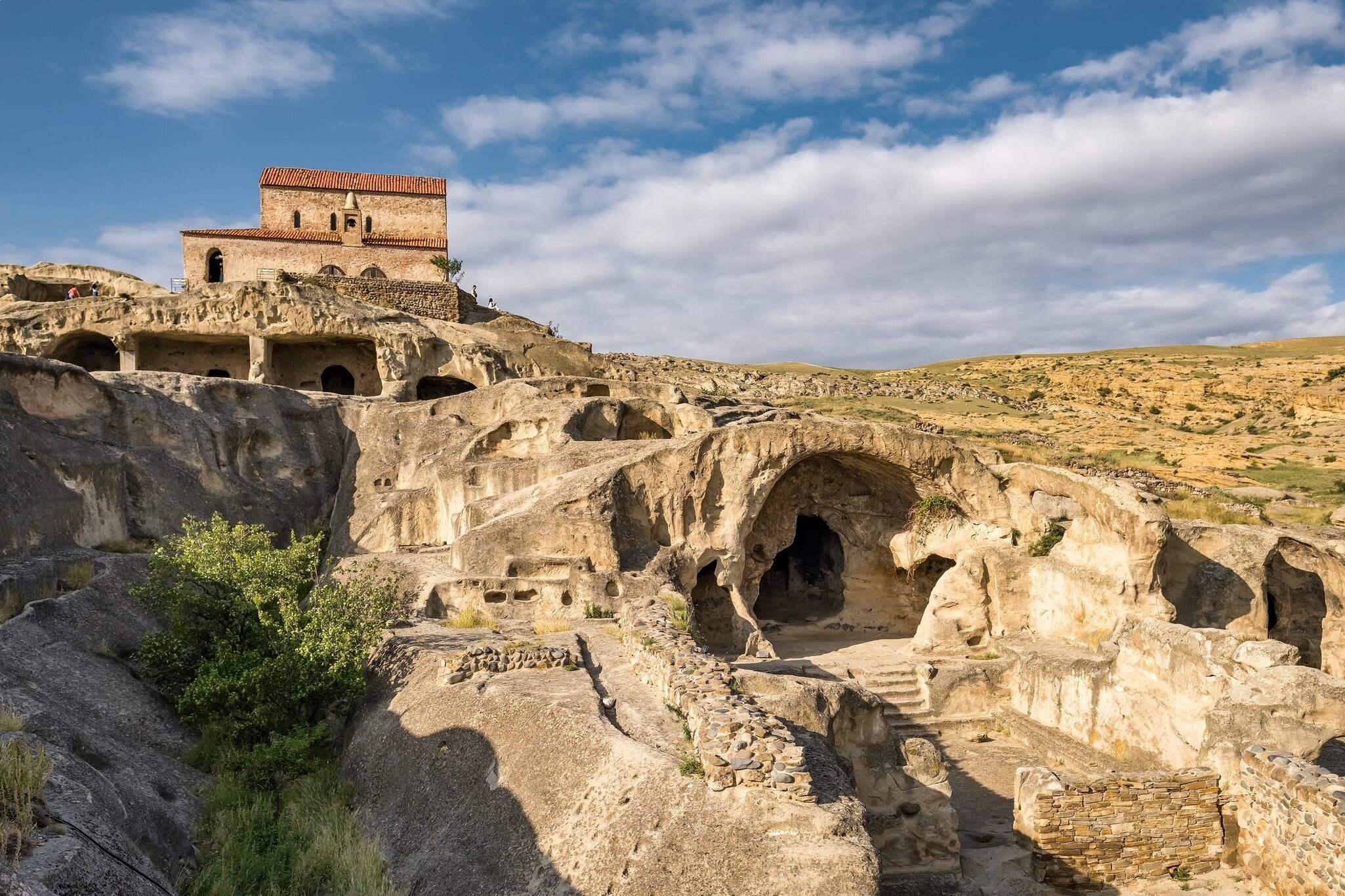 Uplistsikhe cave town near Gori city in Georgia. Ancient cave city Uplistsikhe at sunset in Georgia, UNESCO site.; Shutterstock ID 2108311661; your: Bridget Brown; gl: 65050; netsuite: Online Editorial; full: POI Image Update