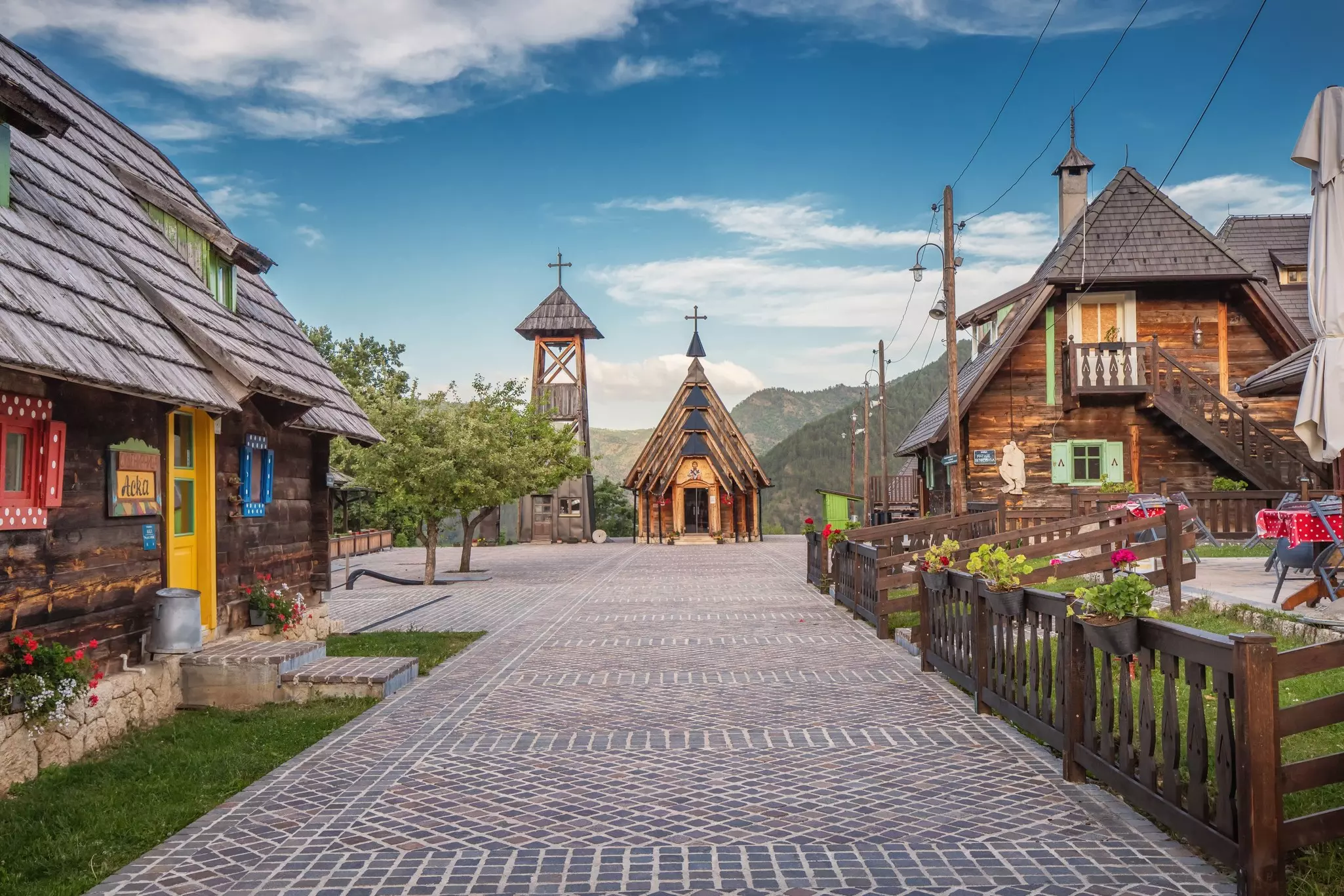 A small village with all houses and the church made of wood.