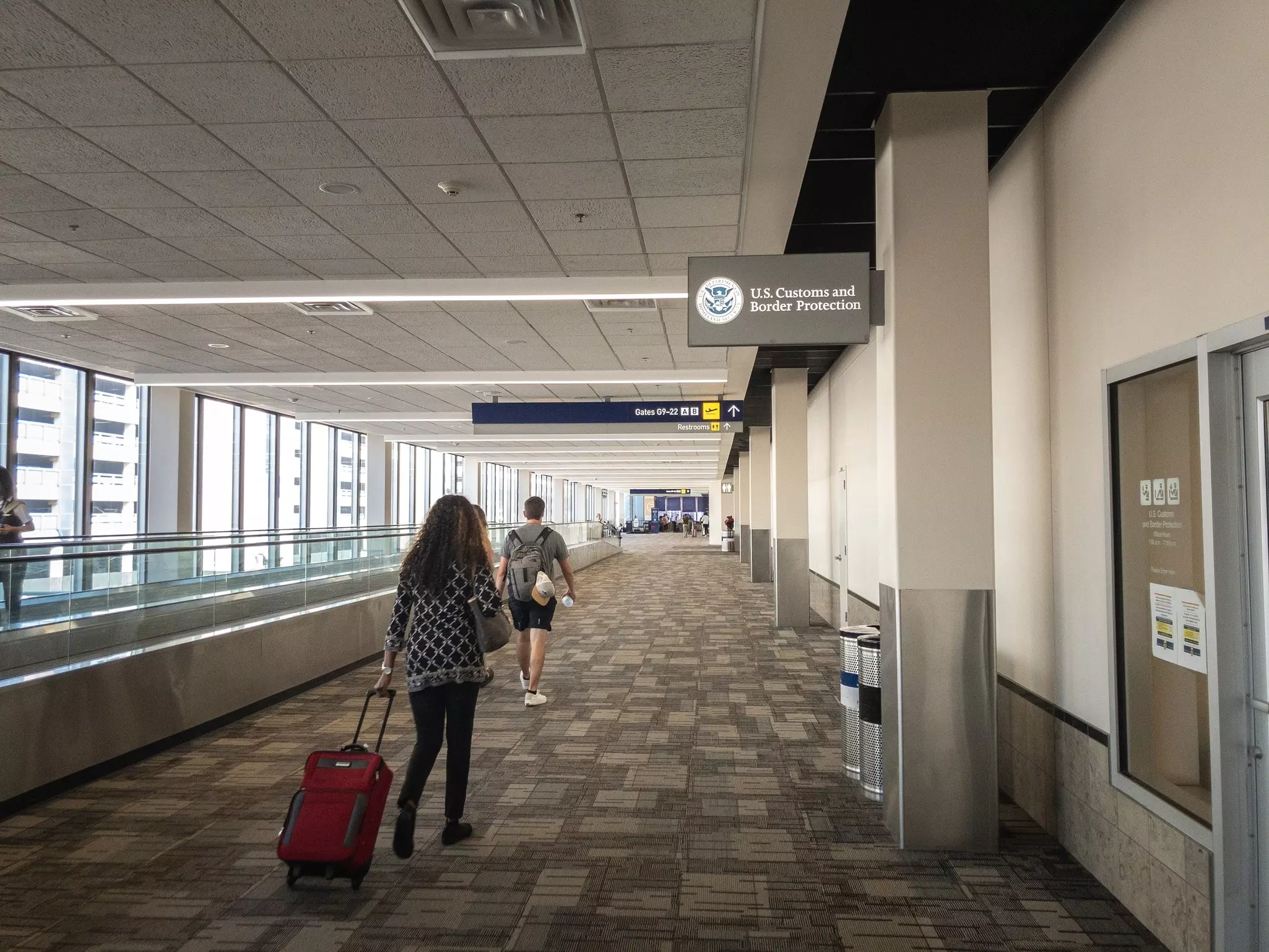 Travelers pass by the US Customs and Border Protection office at Minneapolis–Saint Paul International Airport.