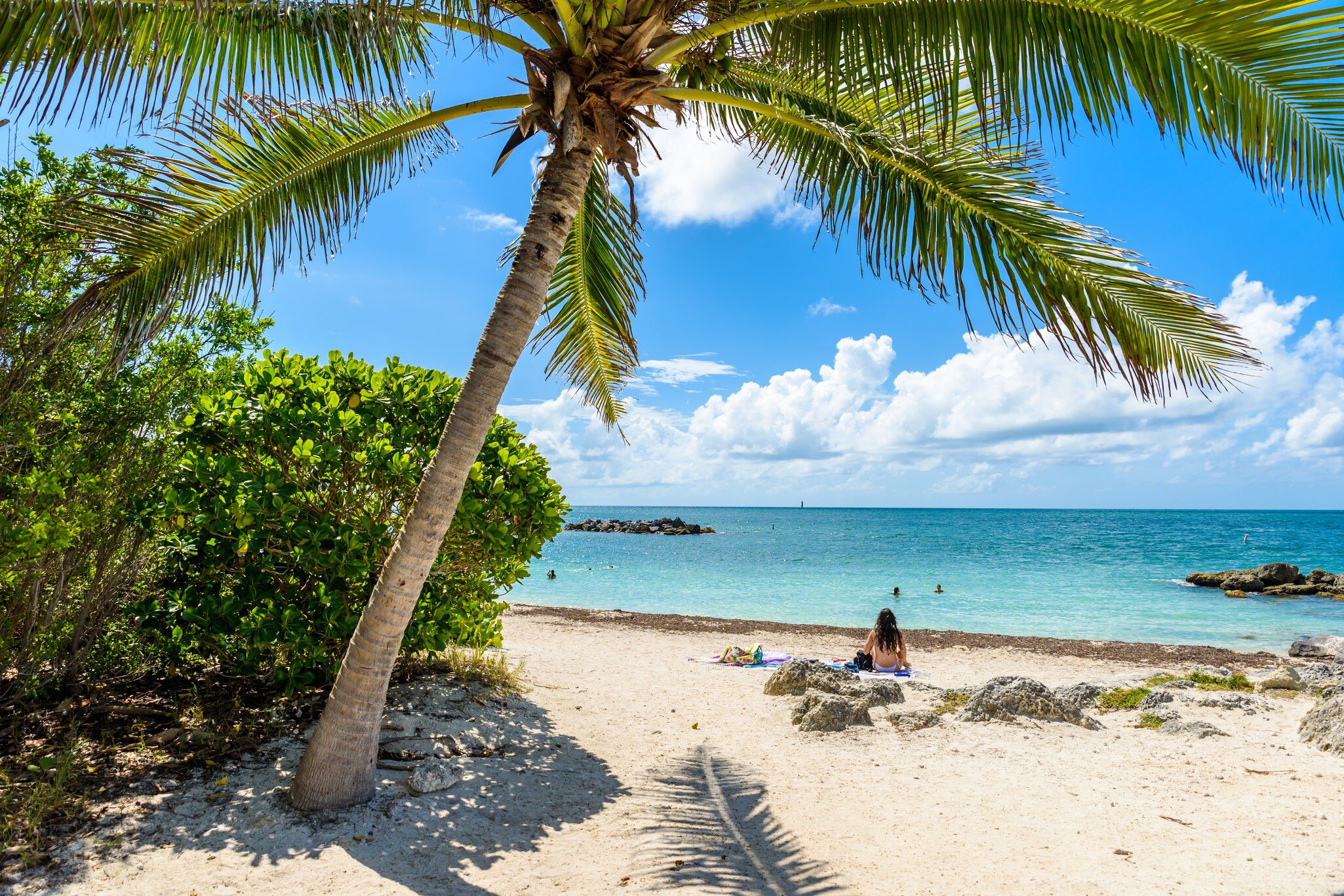 Key West, Florida - December 4, 2019:  People tan and rest on the sunny beach of Fort Zachary Taylor State Park in tropical Key West Florida USA