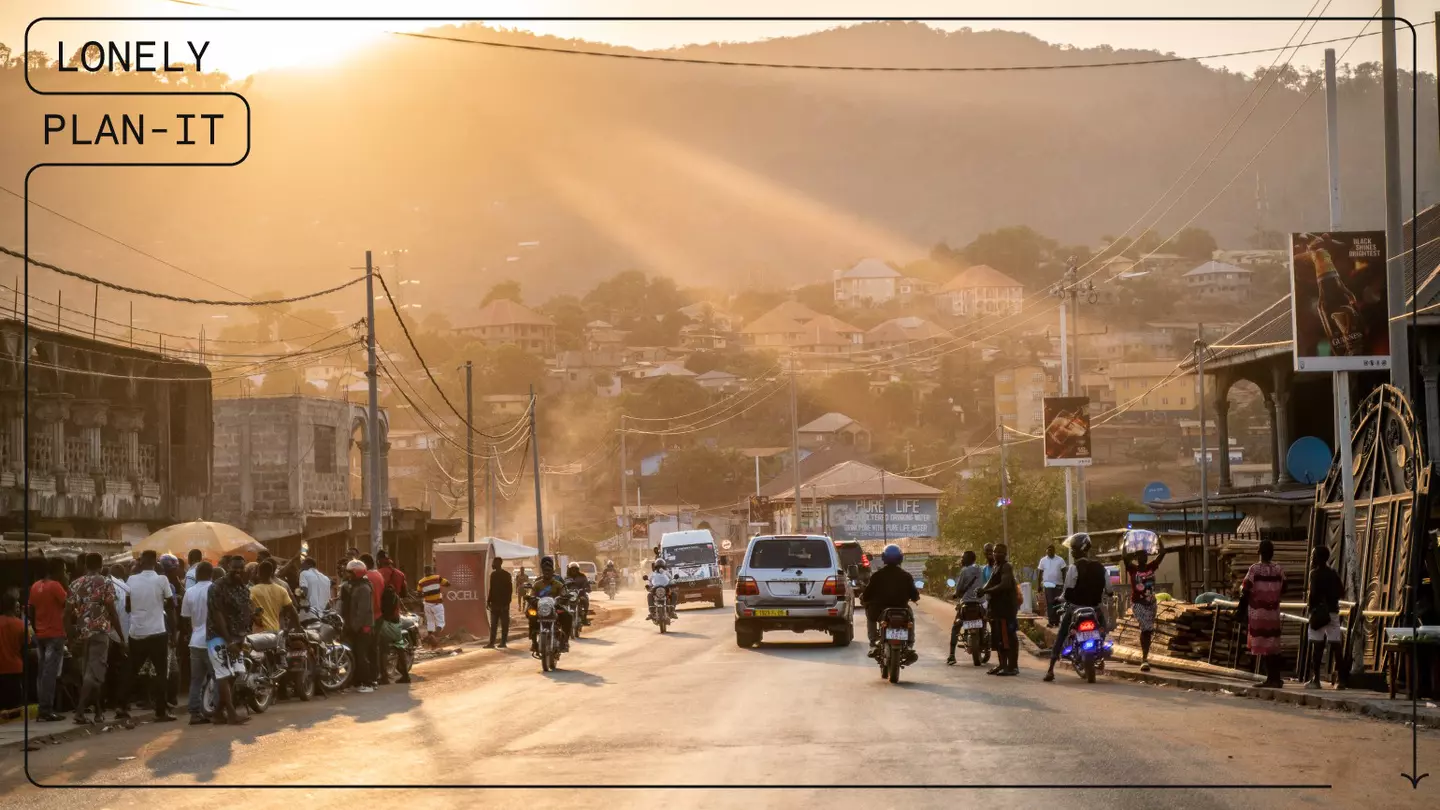 After a full day of driving and one border crossing, the lead car in Juan’s group enters the city of Freetown at sunset © Juan Martinez / Lonely Planet