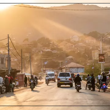 After a full day of driving and one border crossing, the lead car in Juan’s group enters the city of Freetown at sunset © Juan Martinez / Lonely Planet