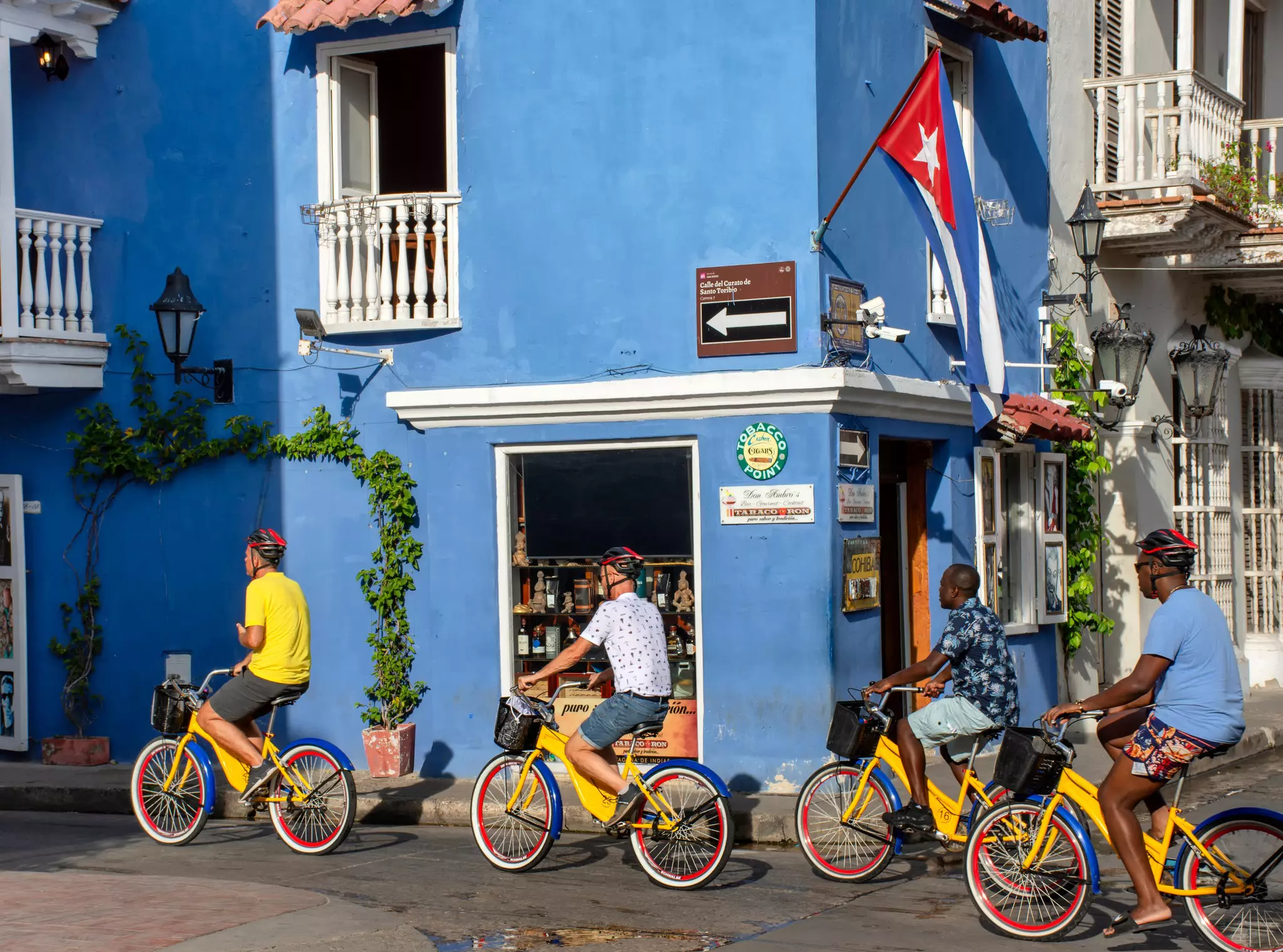 Cyclists on bikes painted in the colors of the Colombian flag in Cartagena, Colombia