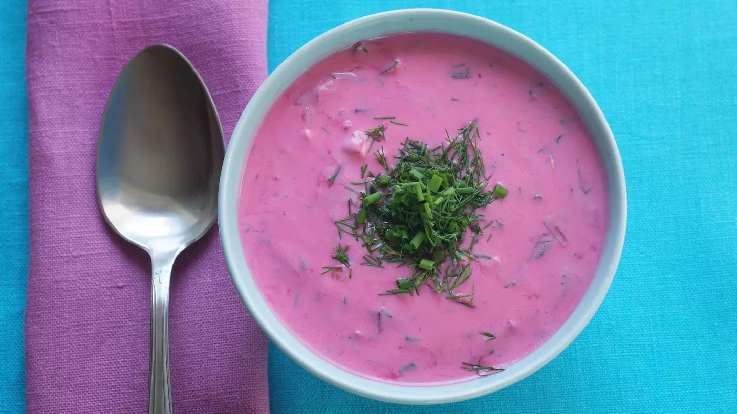 Traditional Polish cold beetroot soup in a bowl on a tablecloth with a napkin. Geo-grafika / Getty Images