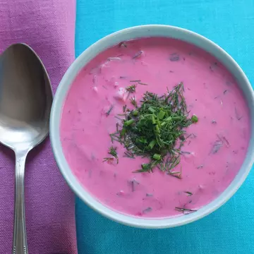 Traditional Polish cold beetroot soup in a bowl on a tablecloth with a napkin. Geo-grafika / Getty Images