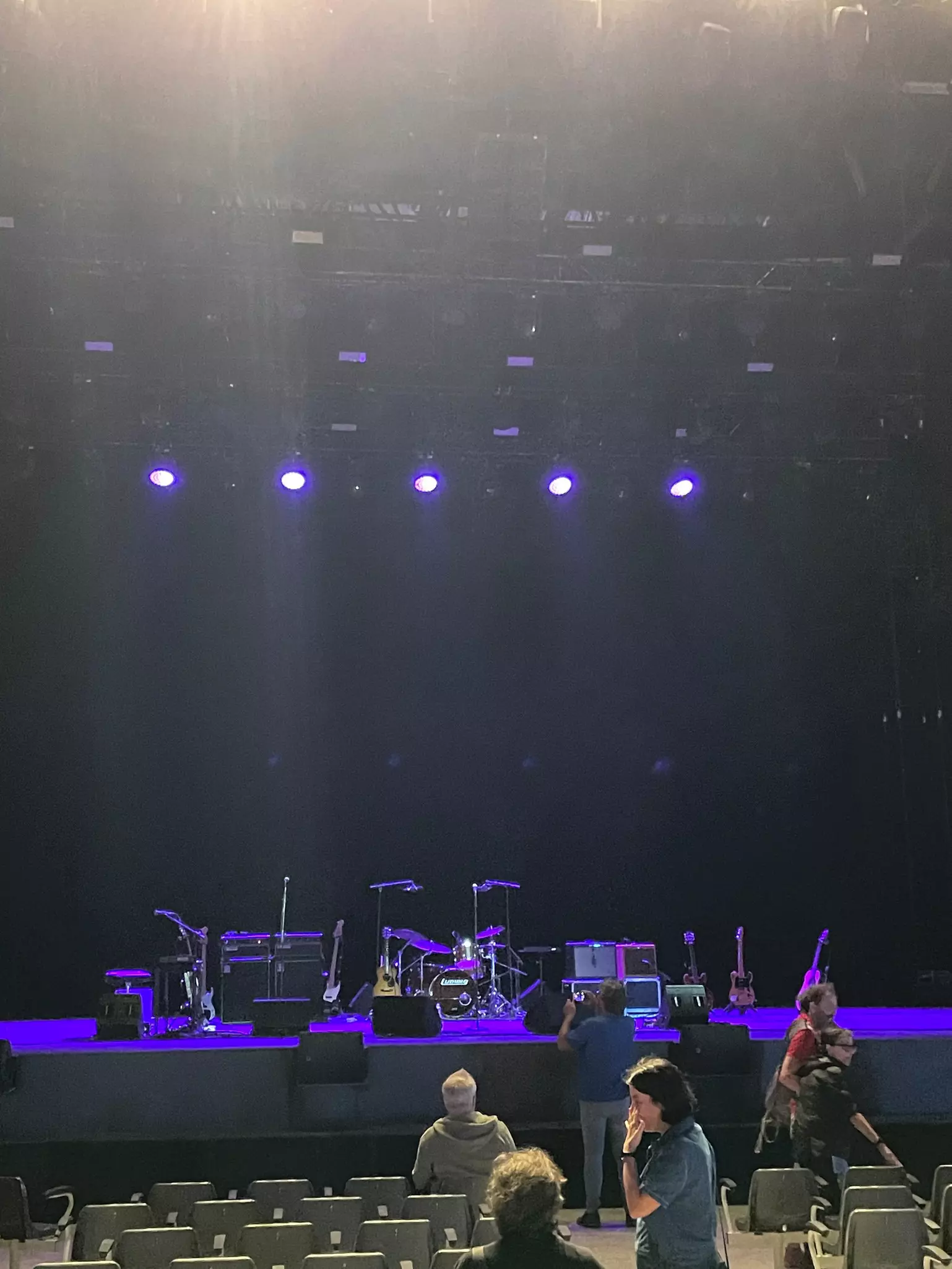 A stage with musical instruments illuminated in blue