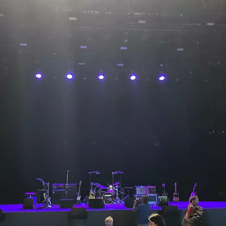 A stage with musical instruments illuminated in blue