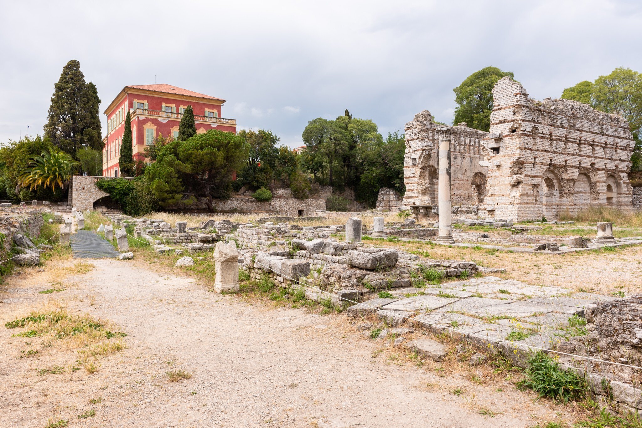 Nice, Alpes-Maritimes, Provence-Alpes-Cote-d’Azur, France. Matisse Museum view from the antic ruins of the Roman Baths of Cimiez.