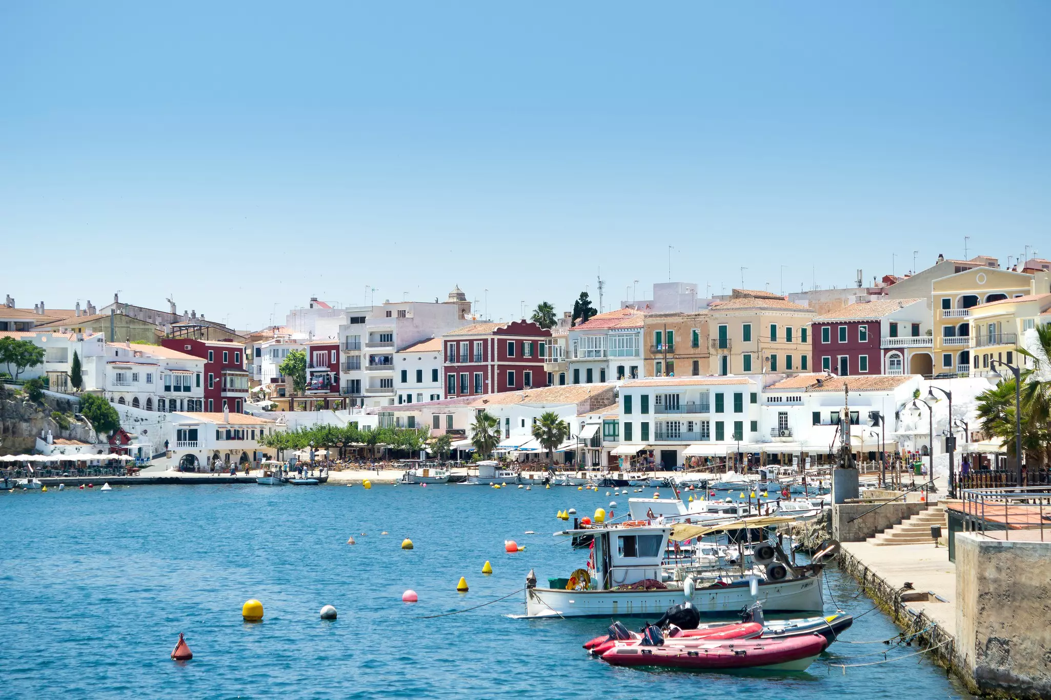 Moll des Cales Fonts harbour with boats moored on the right at the Balearic island Minorca, Menorca