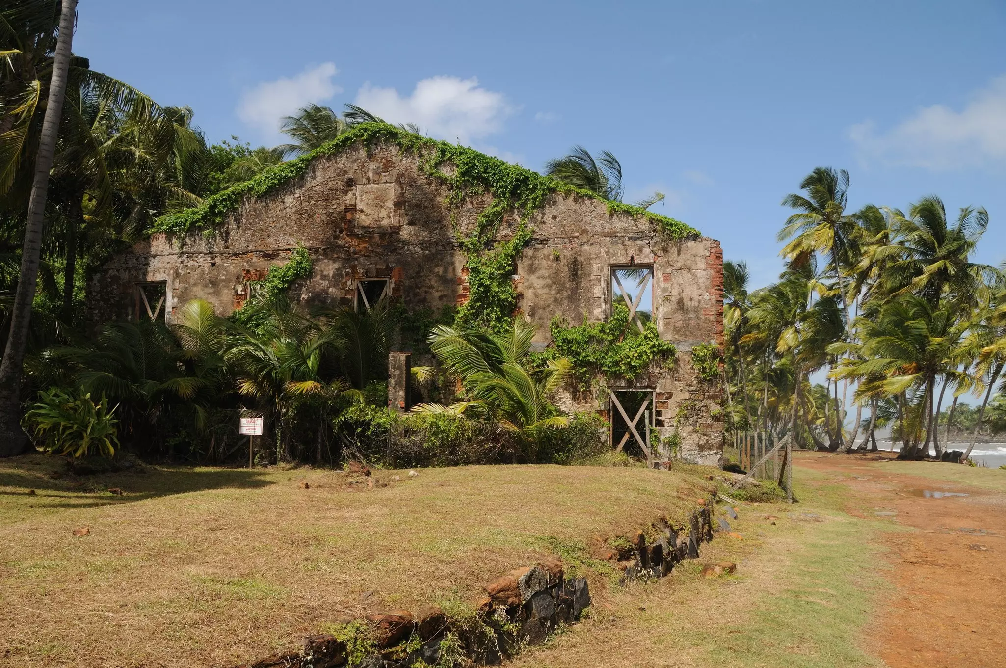 Ruined brick walls from a former prison builsing on a tropical island.