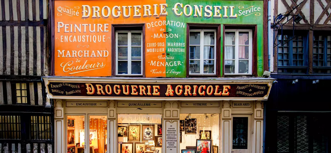 Historic storefront of a drugstore and hardware shop, in a colorful half timbered house, located on a cobbled pedestrian street