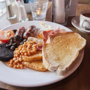 483827044
2015; 261894; Cultures; Drink; Eating; Egg; England; English Culture; Table Knife; Taking a Shot - Sport; Tea - Hot Drink; Toasted Bread; Bacon; Baked Beans; Black Pudding; Breakfast; British Culture; Cafe; Food; Fork; Irish Culture; Republic of Ireland; Sausage; Scotland; Scottish Culture; Serving - Sport; Horizontal; Photography;
Typical English Breakfast Served with Tea