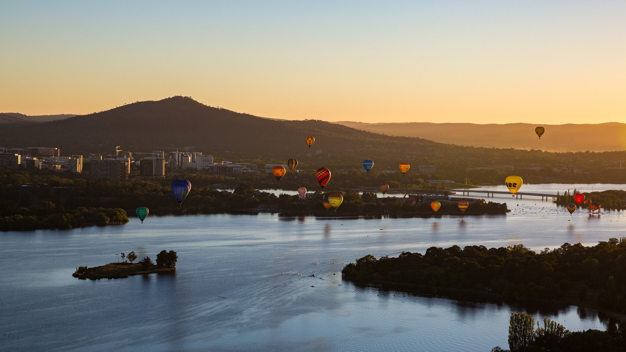 Aerial view from a Hot Air Balloon at sunrise of Lake Burley Griffin and Black Mountain Tower during the Canberra Balloon Spectacular with occurs in March every year in the Australian Capital Territory in Australia