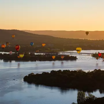 Aerial view from a Hot Air Balloon at sunrise of Lake Burley Griffin and Black Mountain Tower during the Canberra Balloon Spectacular with occurs in March every year in the Australian Capital Territory in Australia