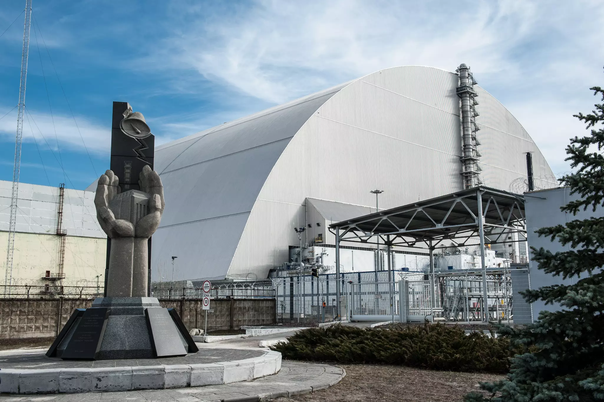 Monument to emergency workers outside Chernobyl, with concrete sculptures of firefighters with hoses tackling the explosion.