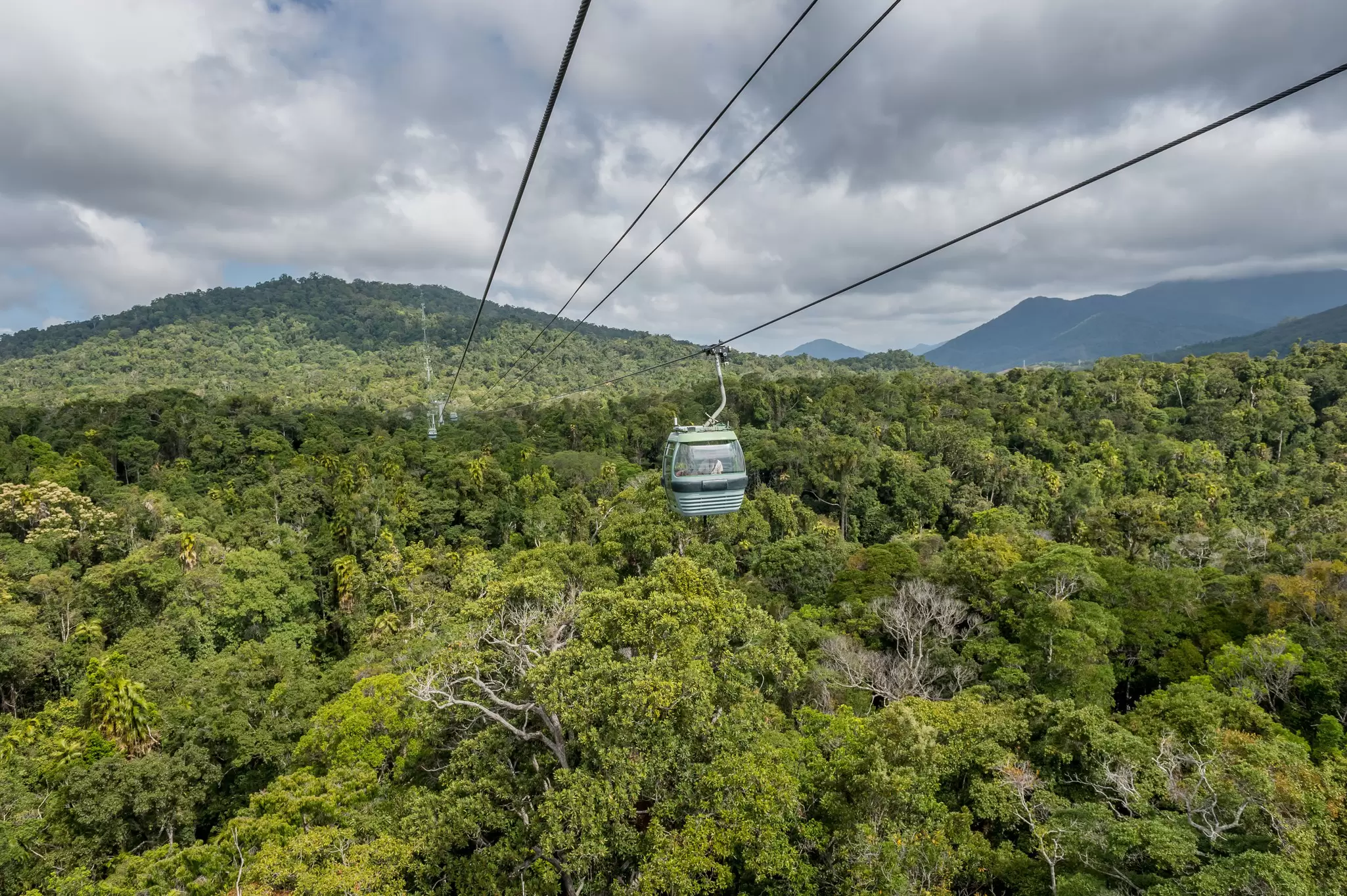 View of the Kuranda Sky Rail cable cars passing over the rainforest in Australia.