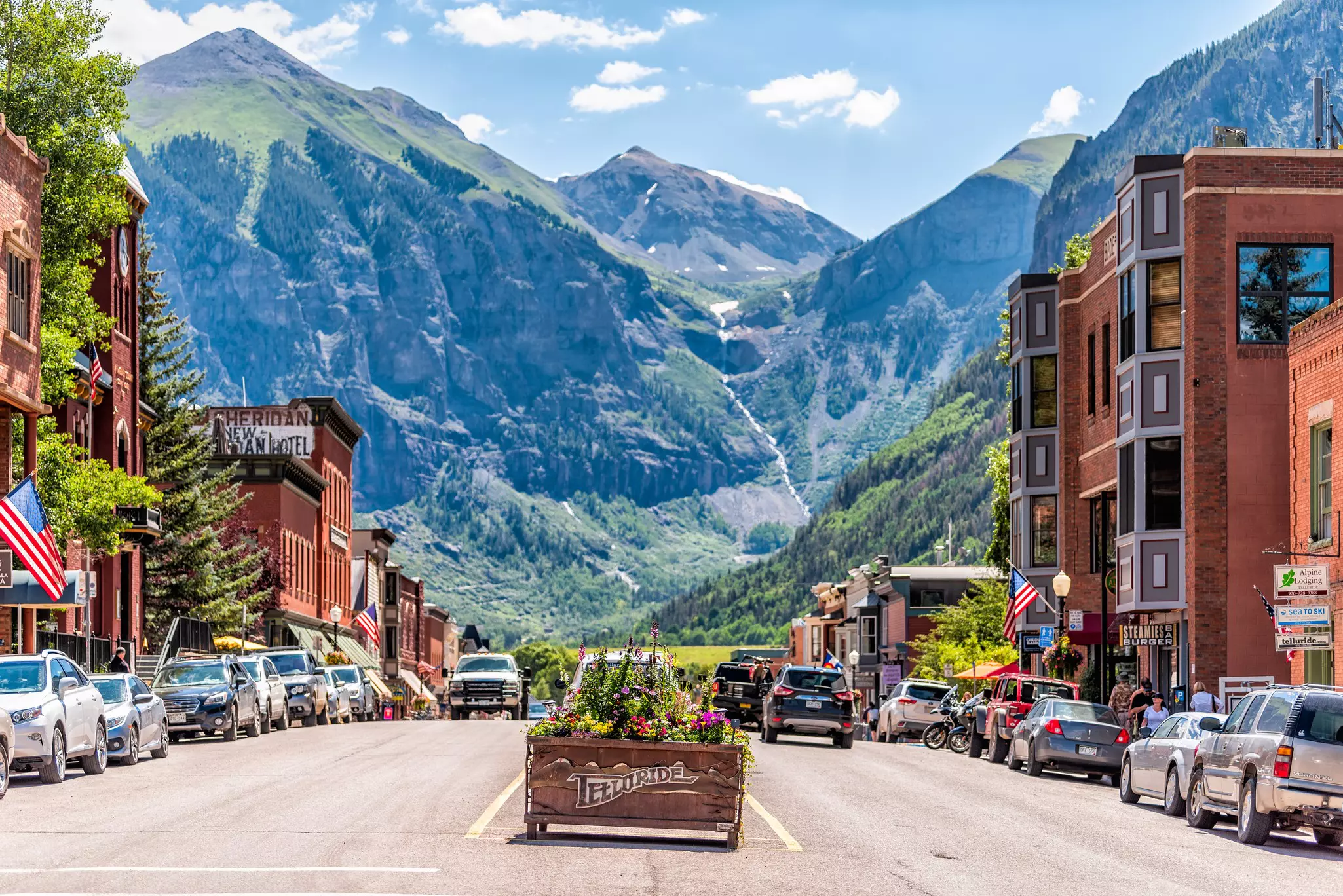 Telluride, USA - August 14, 2019: Small town village in Colorado with sign for city and flowers by historic architecture on main street mountain view  License Type: media  Download Time: 2023-05-12T01:48:02.000Z  User: dermothegarty77  Is Editoria...
