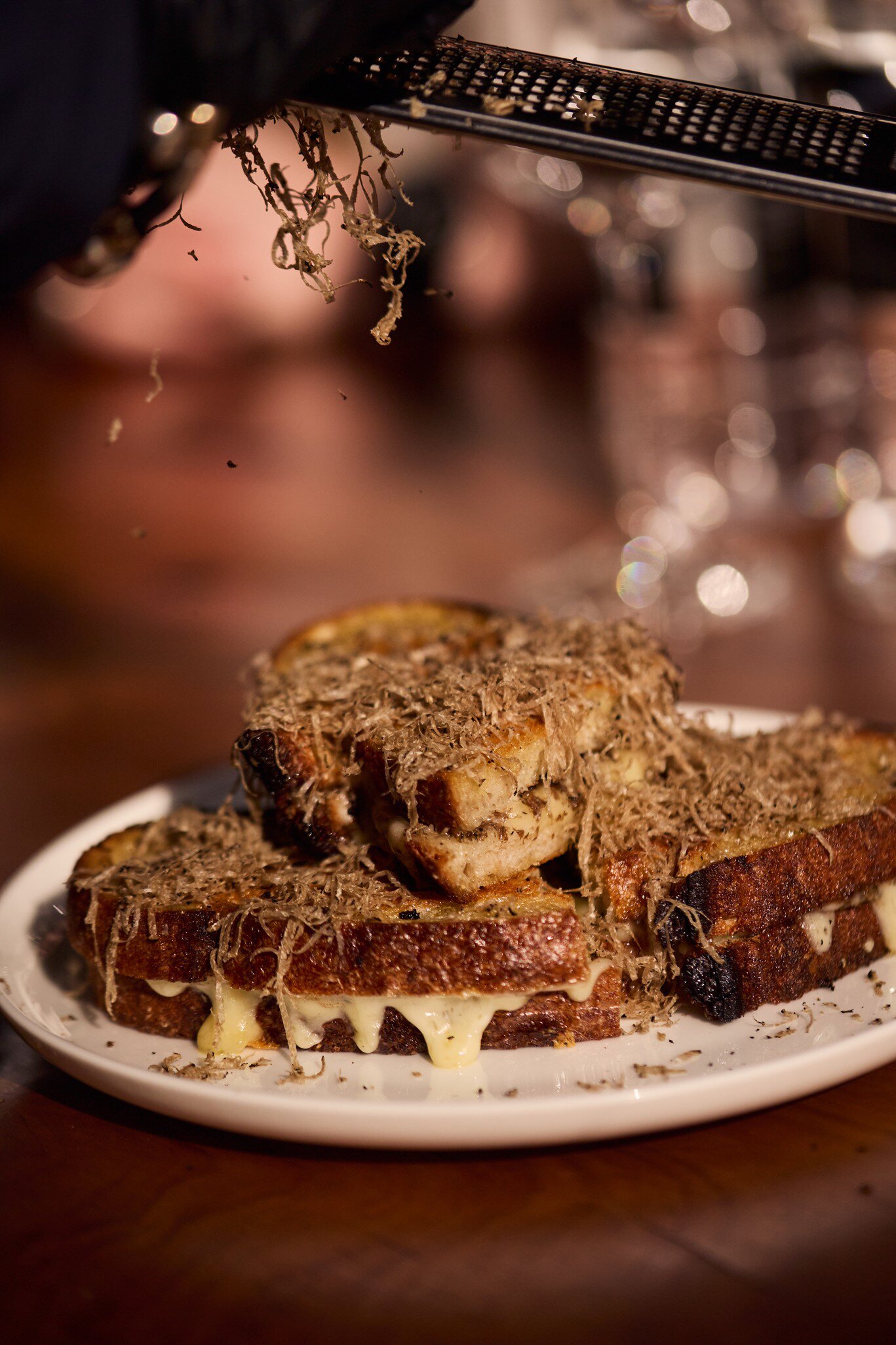 Black truffle grated on a grilled cheese sandwich at The Truffle Farm in Tasmania, Australia. 