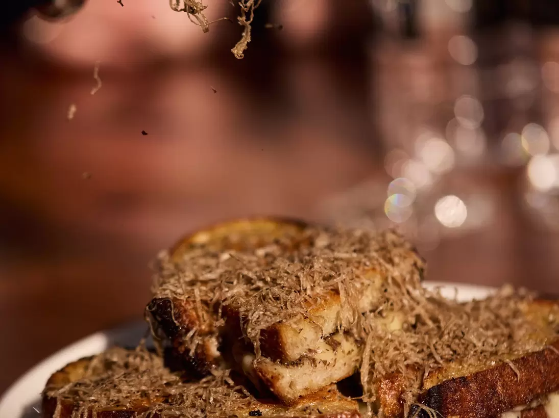 Black truffle grated on a grilled cheese sandwich at The Truffle Farm in Tasmania, Australia. 