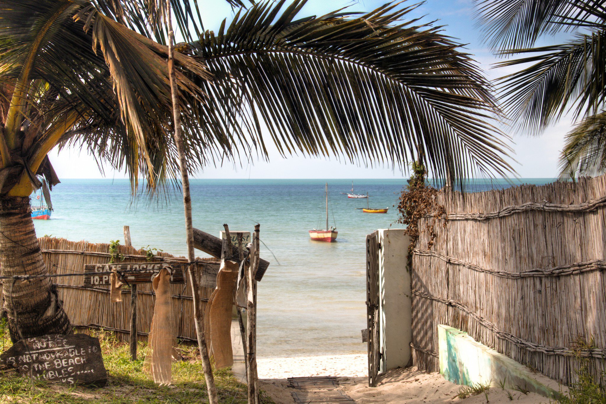 Gate of a guest house in Vilanculos in Mozambique which points to the beach and the Indian Ocean
486713768
Bazaruto, Vilanculos, Travel, Fishing Industry, Dhow, Coastline, Anchored, Tranquil Scene, Blue, Tropical Climate, Transportation, Nature, Sailing, Mozambique, Africa, Palm Tree, Tree, Sand, Beach, Sky, Sea, Water, Fence, Nautical Vessel, Inhambane Province, Vilanculo