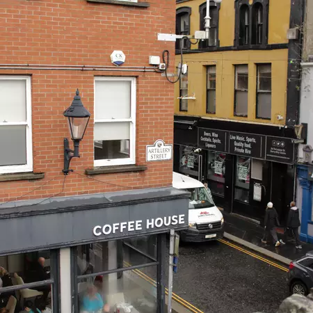 An intersection with a coffeehouse at the corner.