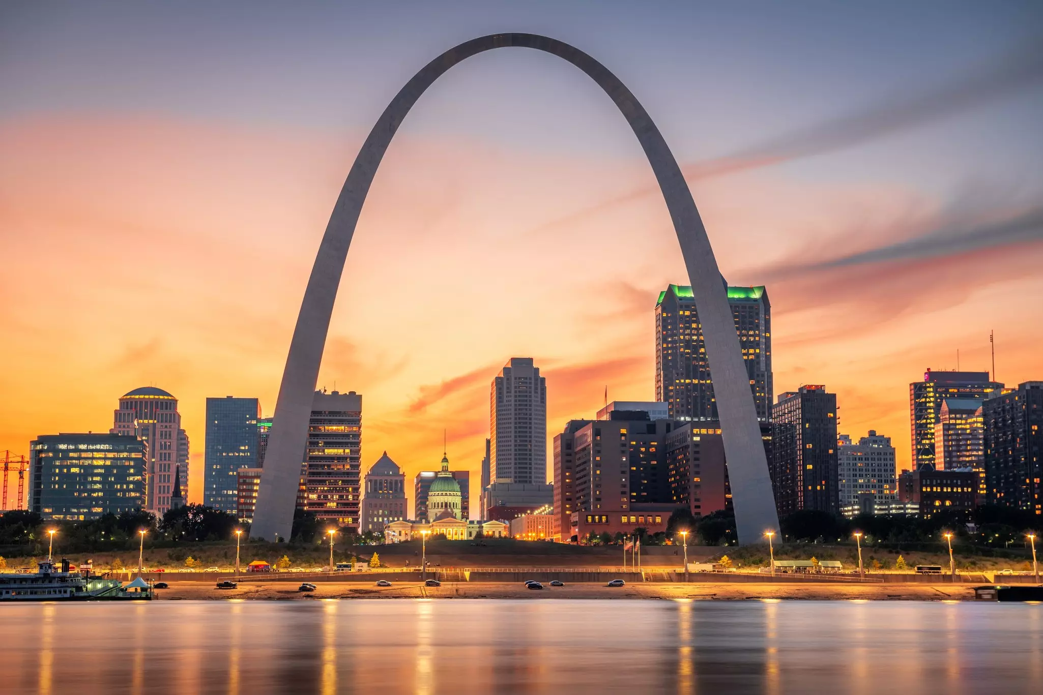 A vast archway over a city at night.