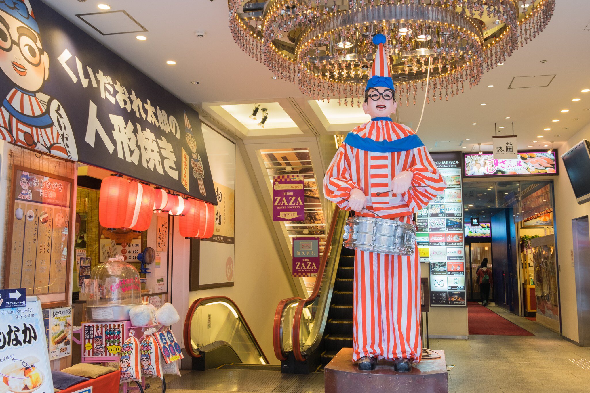 Osaka, Japan - April 27, 2016: The famous Kuidaore Taro Clown in Dotombori Osaka. In front of Cui-daore is a mechanical drum-playing clown, also known as the Kuidaore Ningyo, installed in 1950.  License Type: media  Download Time: 2024-05-22T23:43:18.000Z  User: mvm_lonelyplanet  Is Editorial: Yes  purchase_order:   
