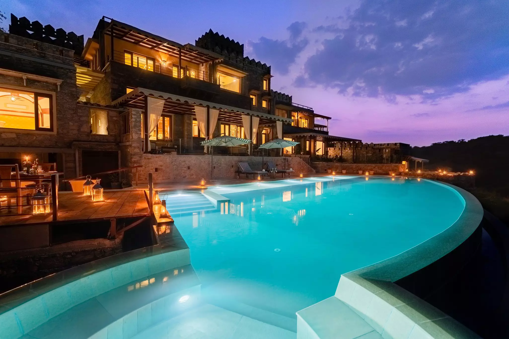 A swimming pool on the terrace of a luxury safari lodge