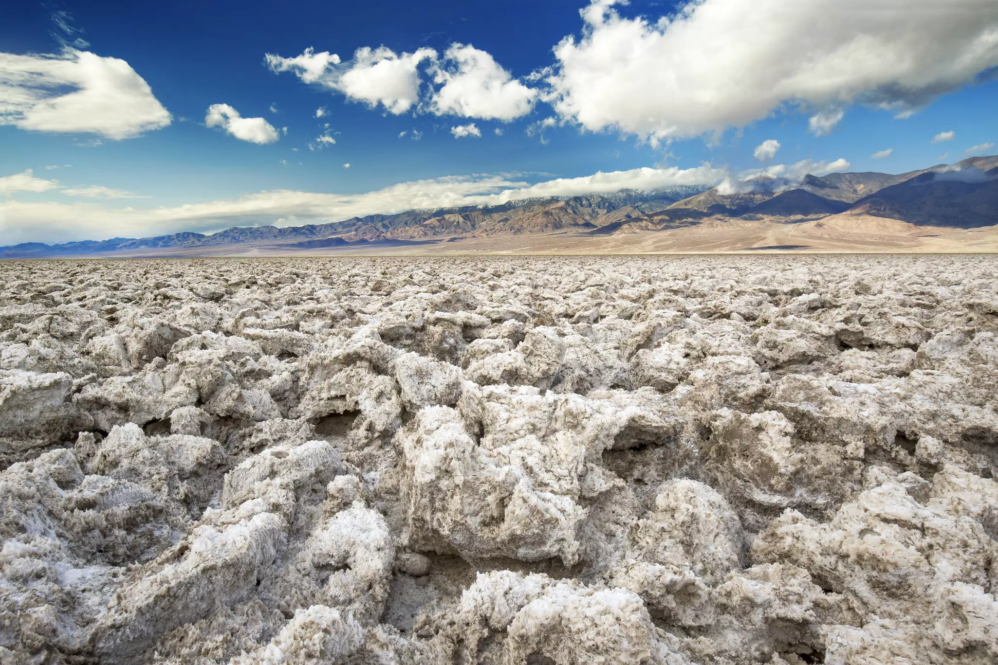 A rough landscape of salt lumps formed from the evaporation of a lake.