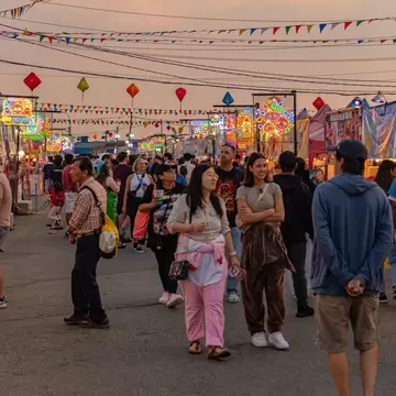 People walking around the local night market in a Chinese neighborhood at twilight in Richmond, Vancouver, BC, Canada.