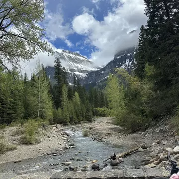 Glacier National Park, Going-to-the-Sun Road, mountains in the background, a river in the foreground. 
