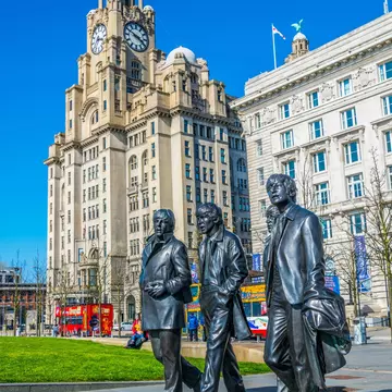 Statue of the Beatles in front of the royal liver building in Liverpool, England.