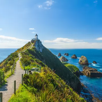 Lighthouse on Nugget Point. It is located in the Catlins area on the Southern Coast of New Zealand, Otago region. The Lighthouse is surrounded by small rock islands, nuggets