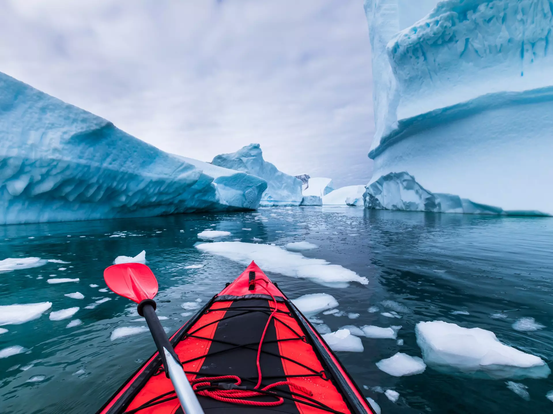 Kayaking in Antarctica between icebergs. NicoElNino / iStock