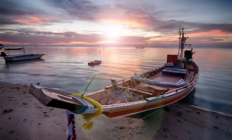 A fishing boat resting on the beach
