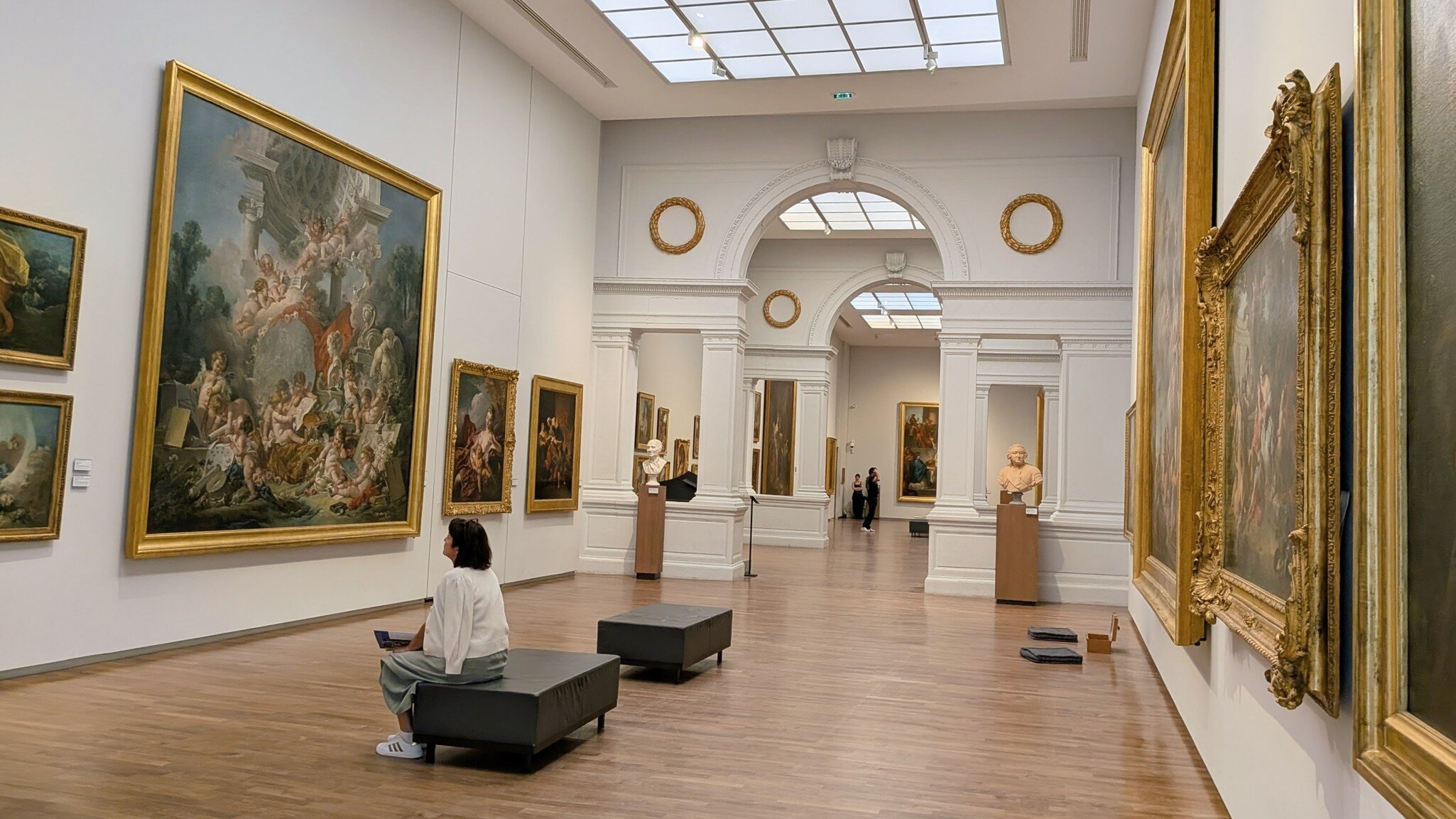 A woman sitting in one of the galleries in the Musée des Beaux Arts, Fine Art Museum, Loire Valley, France.