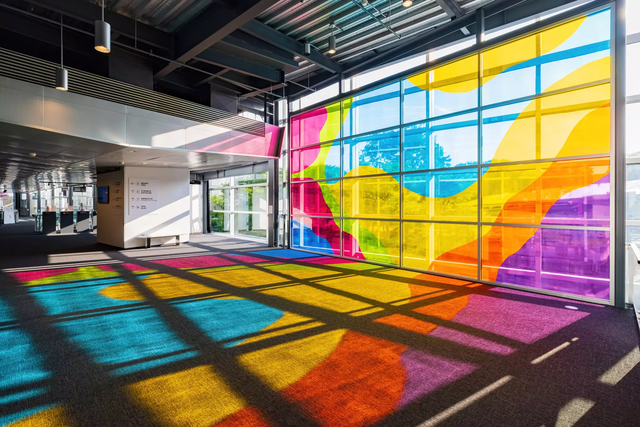 Multicolored glass casts colorful shadows in a museum in New York.