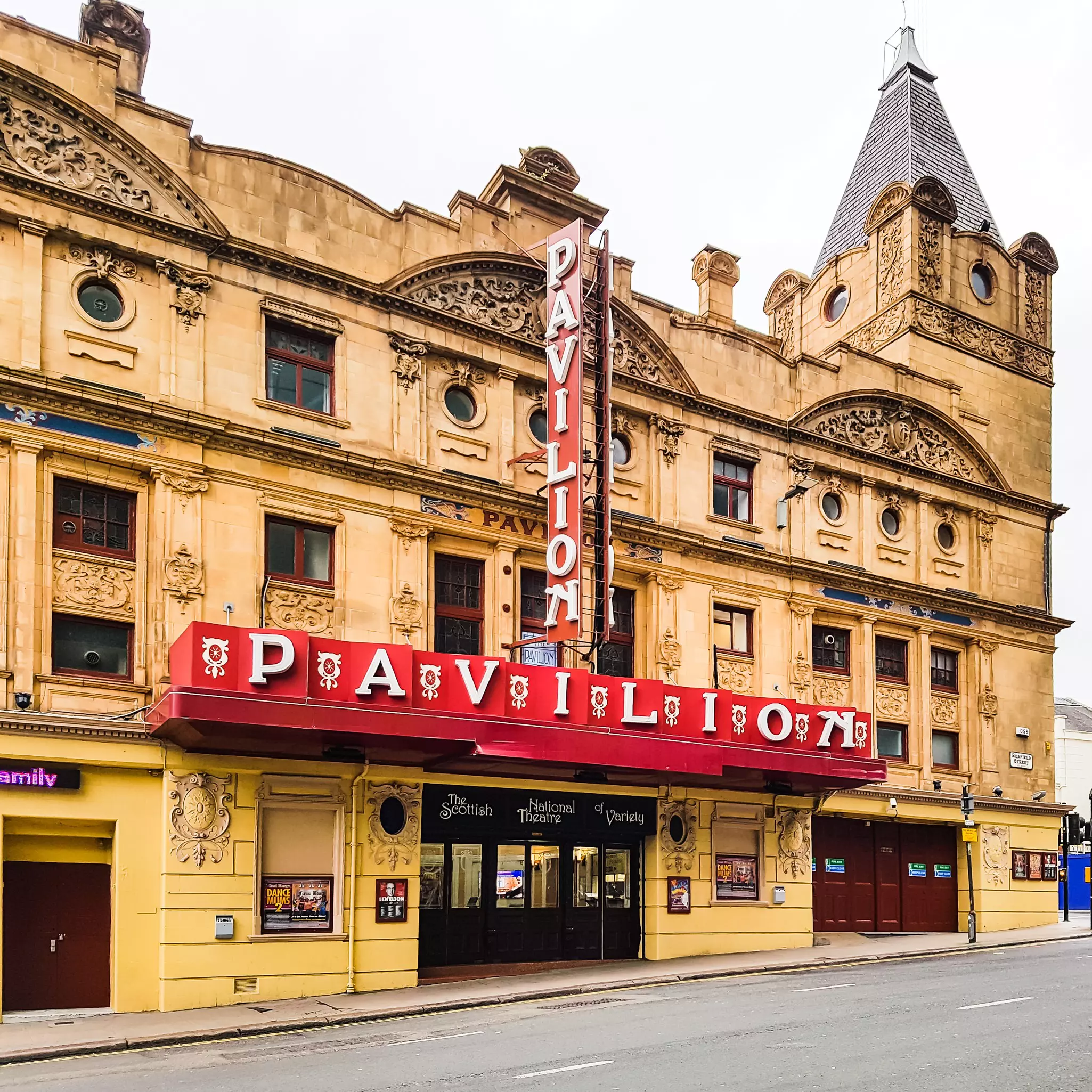 The red marquee of a historic theater in Glasgow, Scotland, reads Pavilion both vertically and horizontally.