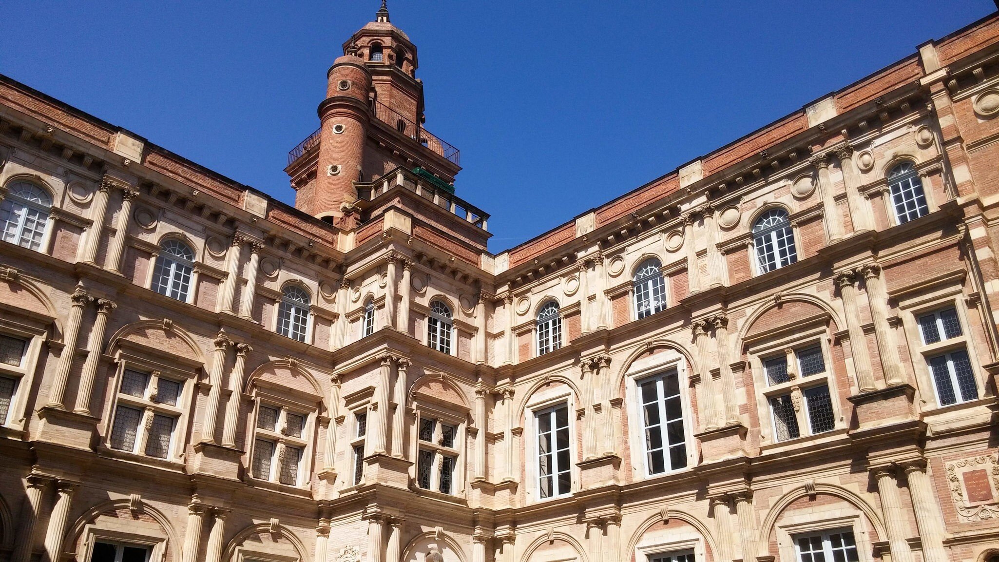 Dec, 2018: Interior facade of the Renaissance-style mansion Hôtel d'Assézat, with its brick tower.