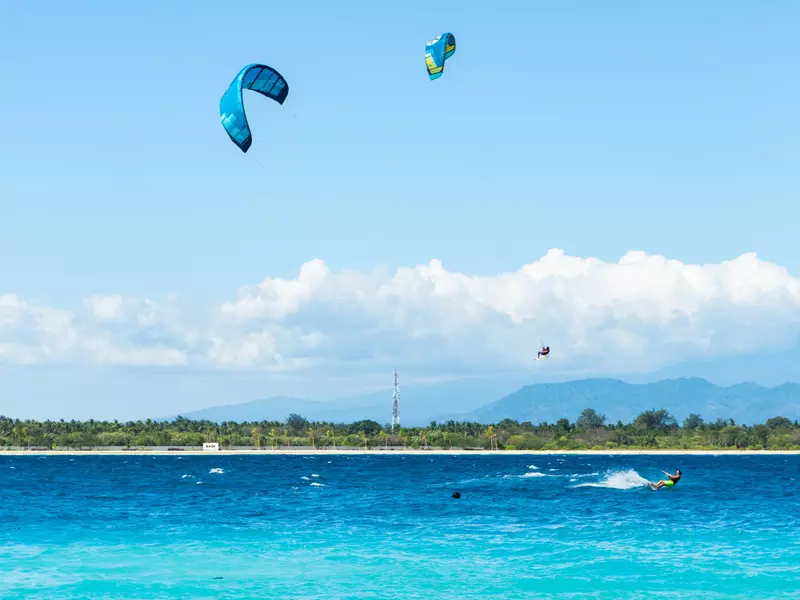 Kitsurfing off Gili Trawangan, with a view of Gili Meno behind, Indonesia.