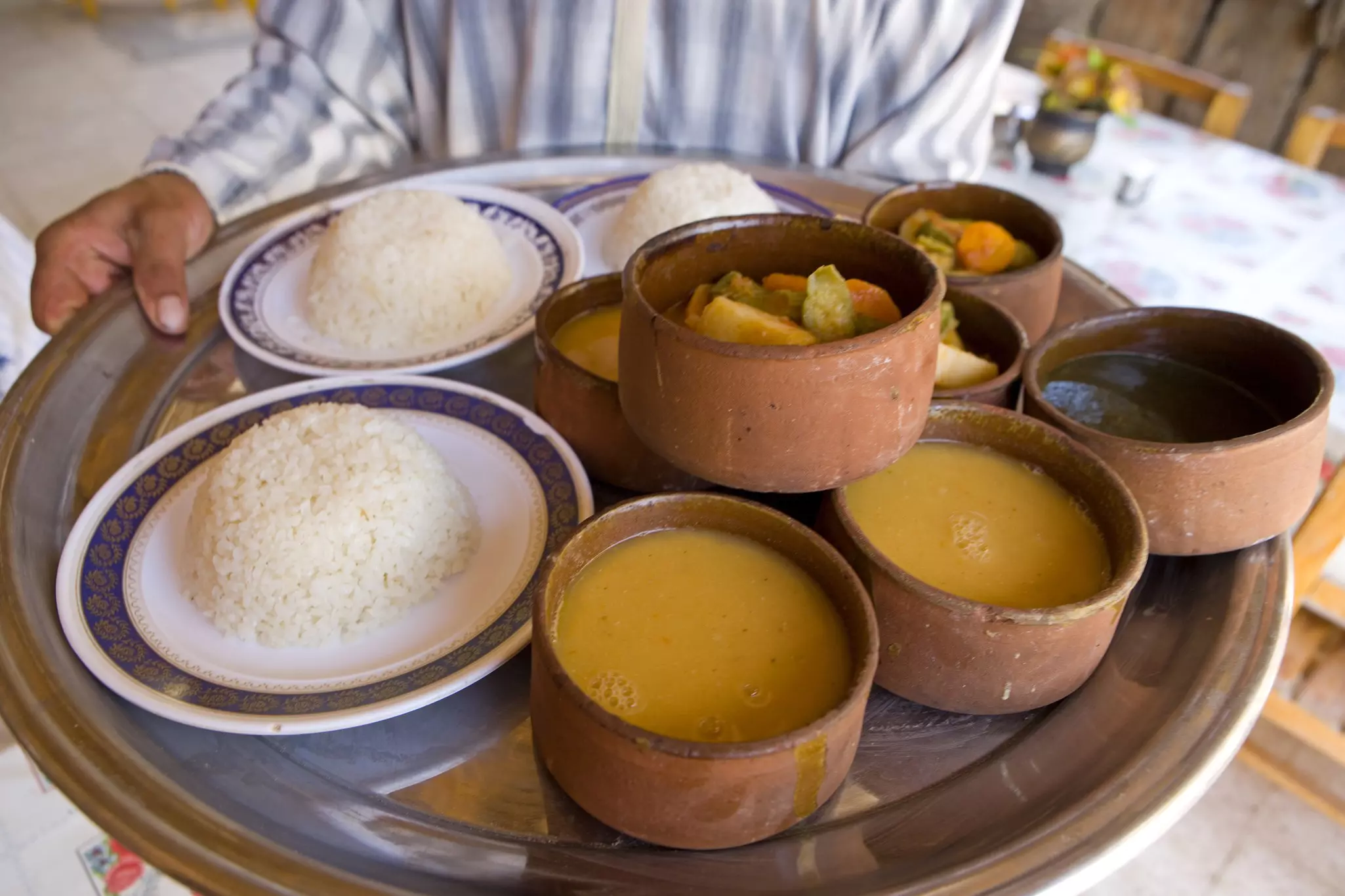 A tray of rice, soup and stewed vegetables in Egypt.