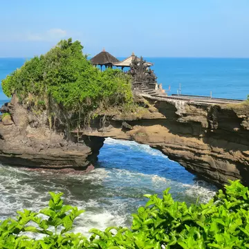 Ocean rock with hole near Pura Batu Bolong temple, Bali, Indonesia