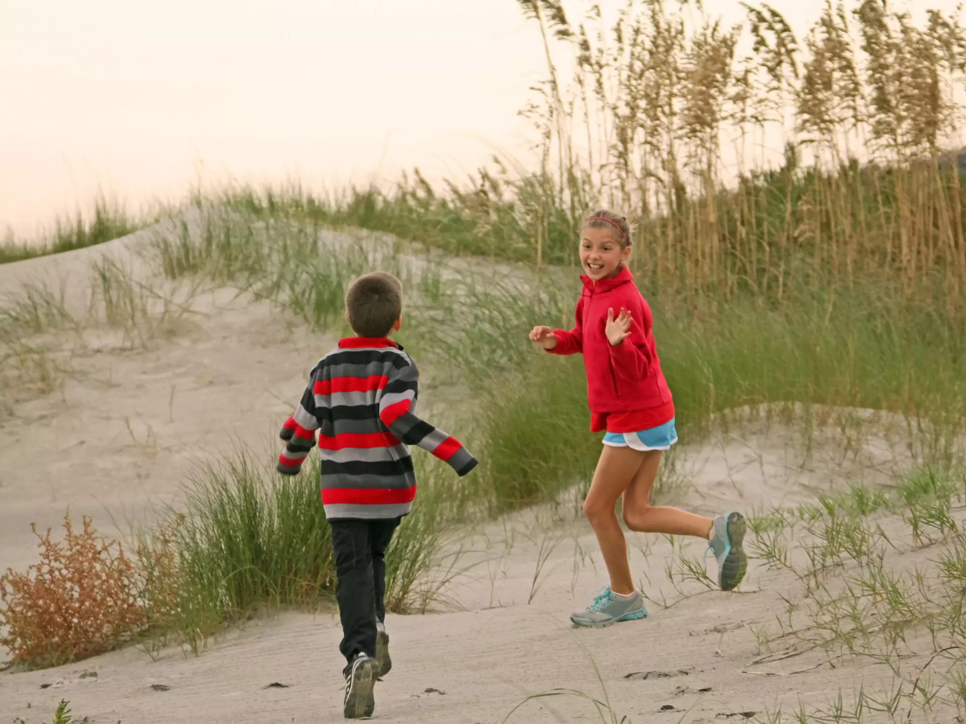 Kids having fun in the dunes on the beach in Sullivan’s Island, near Charleston, South Carolina, The South, USA